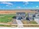 Aerial view of a two-story home showcasing its landscaping and surrounding neighborhood at 5805 Red Barn Ave, Longmont, CO 80504
