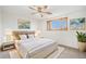 Well-lit bedroom featuring a large bed, decorative art, and a window with a view at 5805 Red Barn Ave, Longmont, CO 80504