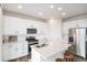 Modern kitchen featuring stainless steel appliances, white cabinetry, and a stylish kitchen island at 5805 Red Barn Ave, Longmont, CO 80504