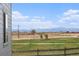 Picturesque view of snow-capped mountains from the property, enhanced by a wooden fence in the foreground at 5805 Red Barn Ave, Longmont, CO 80504