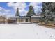 Large backyard with a pergola-covered deck and snowy landscape at 670 S Oswego St, Aurora, CO 80012