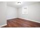 Spacious basement bedroom with hardwood floors and a large window for natural light at 670 S Oswego St, Aurora, CO 80012