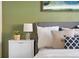 Serene bedroom with gray headboard, white bedding and green accents at 670 S Oswego St, Aurora, CO 80012