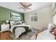 Spacious bedroom with hardwood floors, olive green wall and seating at 670 S Oswego St, Aurora, CO 80012