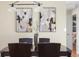 Dining room featuring a dark wood table, modern light fixture and abstract art at 670 S Oswego St, Aurora, CO 80012