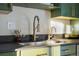 Sleek kitchen sink with gold fixtures and dark countertop at 670 S Oswego St, Aurora, CO 80012