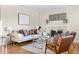 Light and airy living room featuring hardwood floors and a cozy fireplace at 670 S Oswego St, Aurora, CO 80012