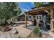 Backyard patio with gazebo and serene landscaping at 6940 Saddleback Ave, Firestone, CO 80504