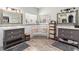 Charming bathroom featuring dual vanities, decorative windows, and a cozy bench at 6940 Saddleback Ave, Firestone, CO 80504