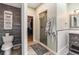 Bathroom showcasing a glass-enclosed shower, toilet, and closet with wood-look flooring at 6940 Saddleback Ave, Firestone, CO 80504