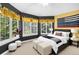Stylish bedroom featuring large windows, modern decor, and ample natural light at 6940 Saddleback Ave, Firestone, CO 80504