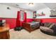 Cozy bedroom featuring a wood bed frame and red accent wall at 6940 Saddleback Ave, Firestone, CO 80504