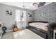 Trendy bedroom with brick accent wall, guitar, and decor at 6940 Saddleback Ave, Firestone, CO 80504