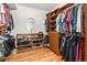 Walk-in closet with custom wood shelving, drawers, and storage for shoes and clothing at 6940 Saddleback Ave, Firestone, CO 80504