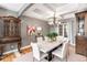 Elegant dining room featuring a marble table, stylish chandelier, and decorative cabinet at 6940 Saddleback Ave, Firestone, CO 80504