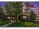 Charming brick home with a welcoming front entrance and well-manicured lawn at 6940 Saddleback Ave, Firestone, CO 80504