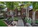Charming brick home with an inviting front entrance, manicured landscaping, and a well-lit walkway at 6940 Saddleback Ave, Firestone, CO 80504