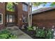 Traditional brick home with a well-kept front yard, walkway, and an American flag on display at 6940 Saddleback Ave, Firestone, CO 80504