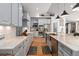 Beautiful kitchen with stainless steel appliances, light blue cabinets, marble countertops, kitchen island, and hardwood floors at 6940 Saddleback Ave, Firestone, CO 80504