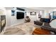 Cozy living room with a fireplace, built-in shelving, a large TV, and comfortable seating at 6940 Saddleback Ave, Firestone, CO 80504