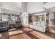 Open-concept living area with hardwood floors, a modern kitchen, and comfortable seating at 6940 Saddleback Ave, Firestone, CO 80504