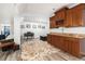 Inviting living room with built-in cabinets, piano, and neutral decor at 6940 Saddleback Ave, Firestone, CO 80504