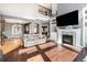 Open living space with hardwood floors, fireplace, and views into dining room and foyer at 6940 Saddleback Ave, Firestone, CO 80504