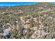Scenic aerial shot of a mountain community nestled amidst trees, rocks, and snowy landscape at 21437 Alta Dr, Morrison, CO 80465