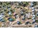 Stunning aerial view of a mountain home nestled among lush green trees and snowy patches at 21437 Alta Dr, Morrison, CO 80465