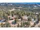Bird's-eye view reveals the home, detached garage, and a lush forested landscape at 21437 Alta Dr, Morrison, CO 80465