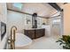 Elegant bathroom featuring a freestanding tub, marble floors, and a double vanity at 21437 Alta Dr, Morrison, CO 80465
