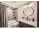 Modern bathroom featuring a shower-tub combination and decorative tile at 21437 Alta Dr, Morrison, CO 80465