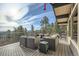 Beautiful exterior deck with comfortable seating and picturesque views of the forest at 21437 Alta Dr, Morrison, CO 80465