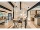 Dining room features an exposed ceiling, brick wall, and access to the kitchen at 21437 Alta Dr, Morrison, CO 80465