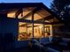 Exterior view of house featuring large windows showing the interior with deck furniture on the patio at 21437 Alta Dr, Morrison, CO 80465