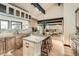 Bright kitchen features wood cabinets, granite countertops, and a large island with seating at 21437 Alta Dr, Morrison, CO 80465