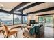 Bright and spacious living room featuring a stone fireplace, wood floors, and a scenic view at 21437 Alta Dr, Morrison, CO 80465