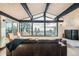 Bright and airy living room featuring exposed beams, wood floors, and stunning mountain views at 21437 Alta Dr, Morrison, CO 80465