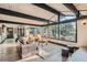 Open concept living room featuring exposed beams, wood floors, fireplace, and scenic views at 21437 Alta Dr, Morrison, CO 80465