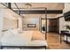 Spacious main bedroom with fireplace, hardwood floors, modern lighting, and access to the main bathroom at 21437 Alta Dr, Morrison, CO 80465
