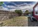 A view of the partially fenced backyard, showing some grass and unkempt shrubbery at 1334 Xavier St, Denver, CO 80204