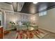 Inviting basement living room with a comfortable sectional sofa, coffee table, and decorative art at 1334 Xavier St, Denver, CO 80204
