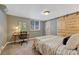 A bedroom featuring a desk and a wooden closet door at 1334 Xavier St, Denver, CO 80204