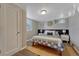 A cozy bedroom featuring carpet, a bed, and a wooden closet door at 1334 Xavier St, Denver, CO 80204