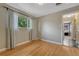 Bedroom with hardwood floors, window with patterned curtains, and a view into the hallway at 1334 Xavier St, Denver, CO 80204