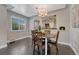 Dining room with wood floors and an open view to a kitchen featuring modern lighting at 1334 Xavier St, Denver, CO 80204