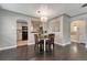 Dining area with hardwood floors looks to the kitchen, with a table, chairs, and stylish pendant lighting at 1334 Xavier St, Denver, CO 80204