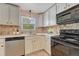 Bright kitchen with modern appliances, white cabinets and tiled backsplash at 1334 Xavier St, Denver, CO 80204