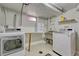 Functional laundry room features washer, dryer, wash sink and storage space at 1334 Xavier St, Denver, CO 80204