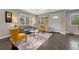 Sunlit living room with a comfortable seating arrangement, hardwood floors, and a view of the exterior at 1334 Xavier St, Denver, CO 80204